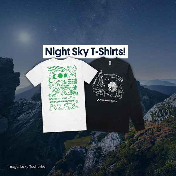 Two 'Night Sky' Wilderness t-shirts are overlayed on top of a stunning photo of Southwest National Park (lutruwita/Tasmania) at night.